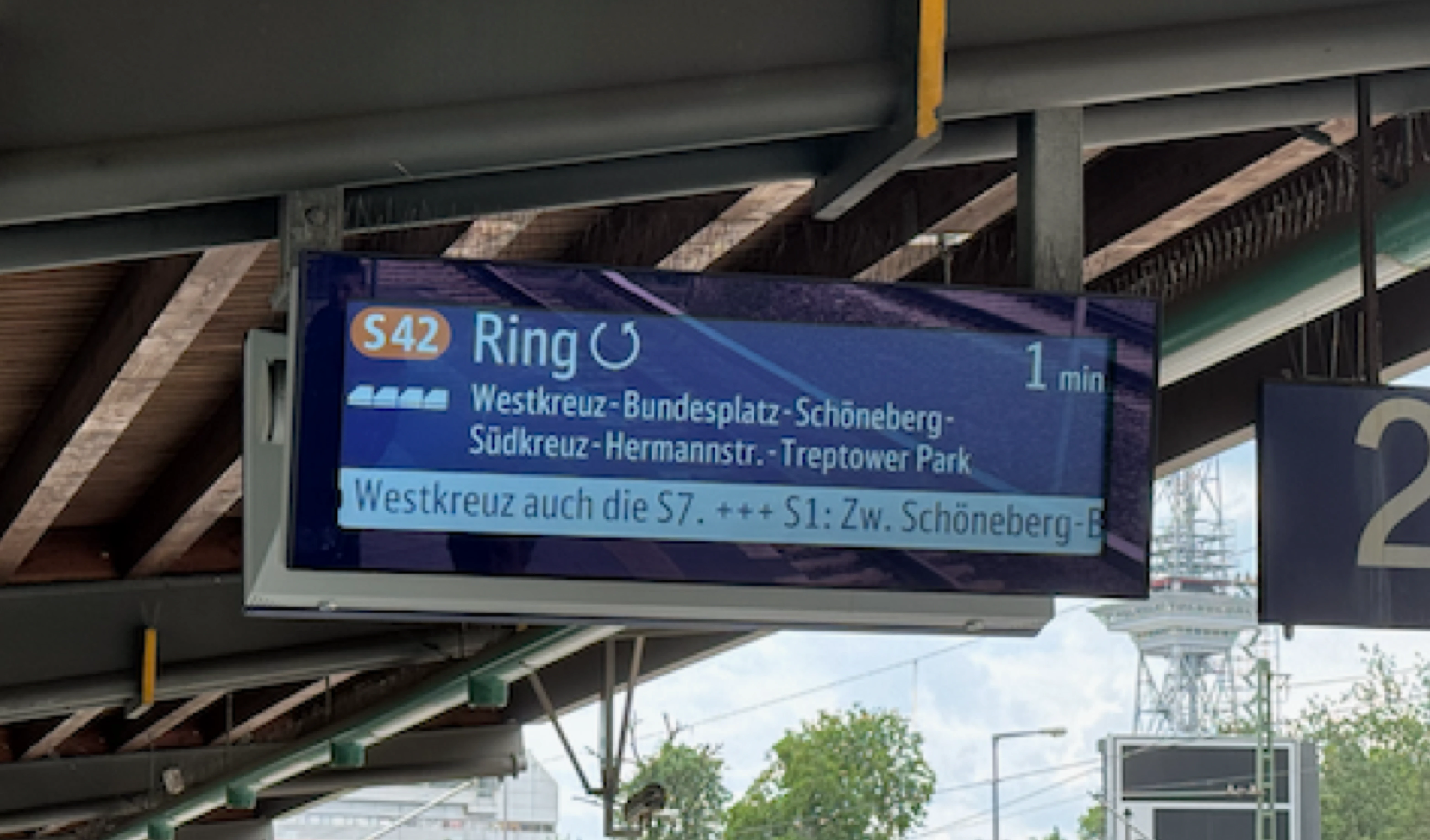 Train information on a digital board showing the line, expected arrival and stops.